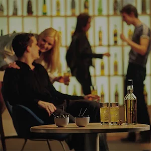 Two people having a discussion in a classy cocktail lounge